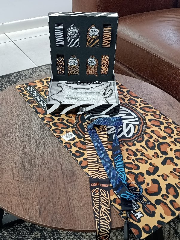 Packaging with zebra pattern and 'TJOFE' branding, featuring small items inside.